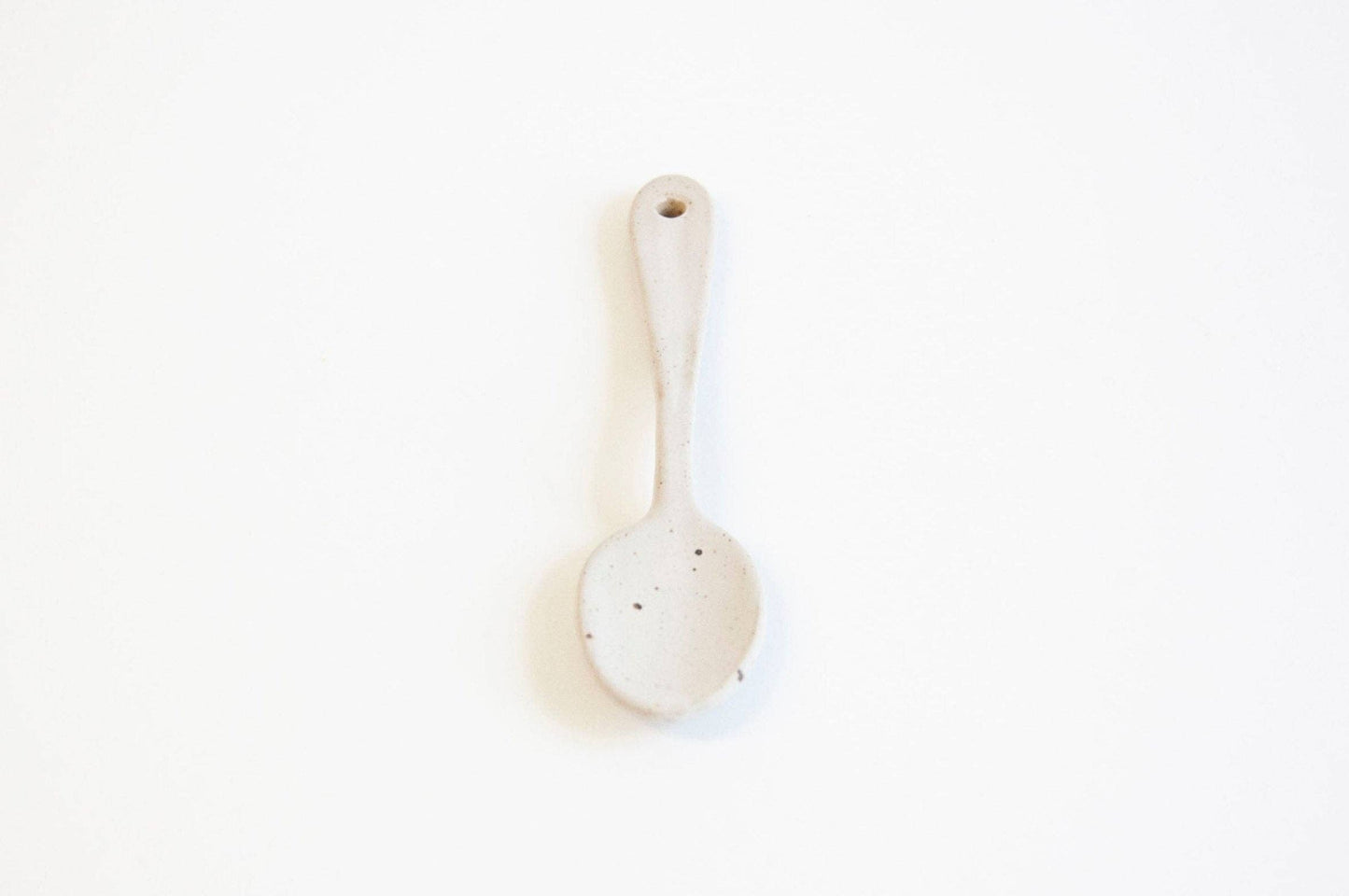 White ceramic spoon on a white background