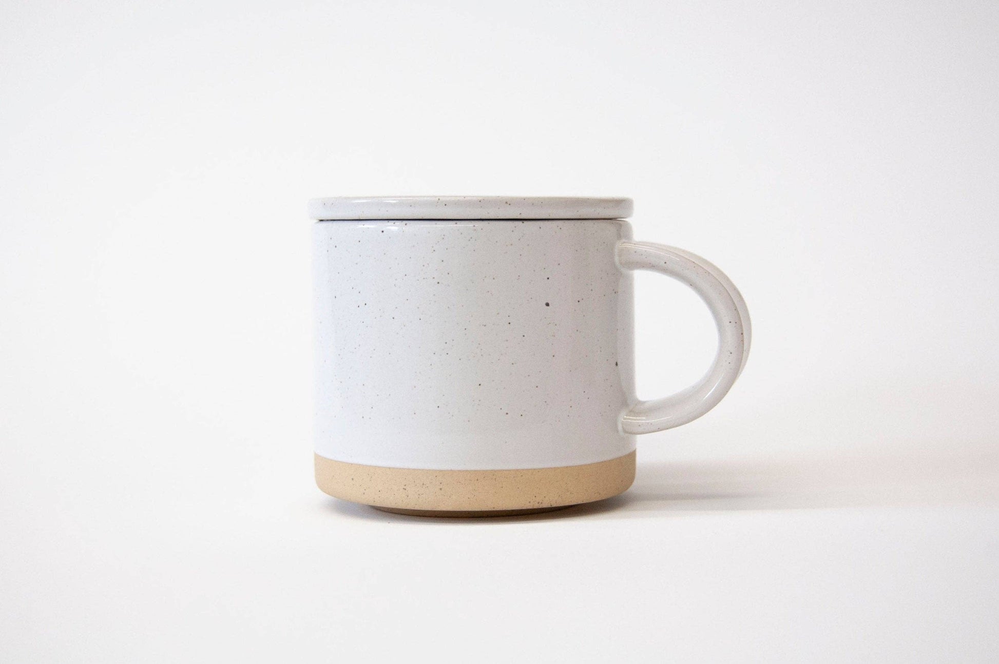 White ceramic mug with beige base on a white background