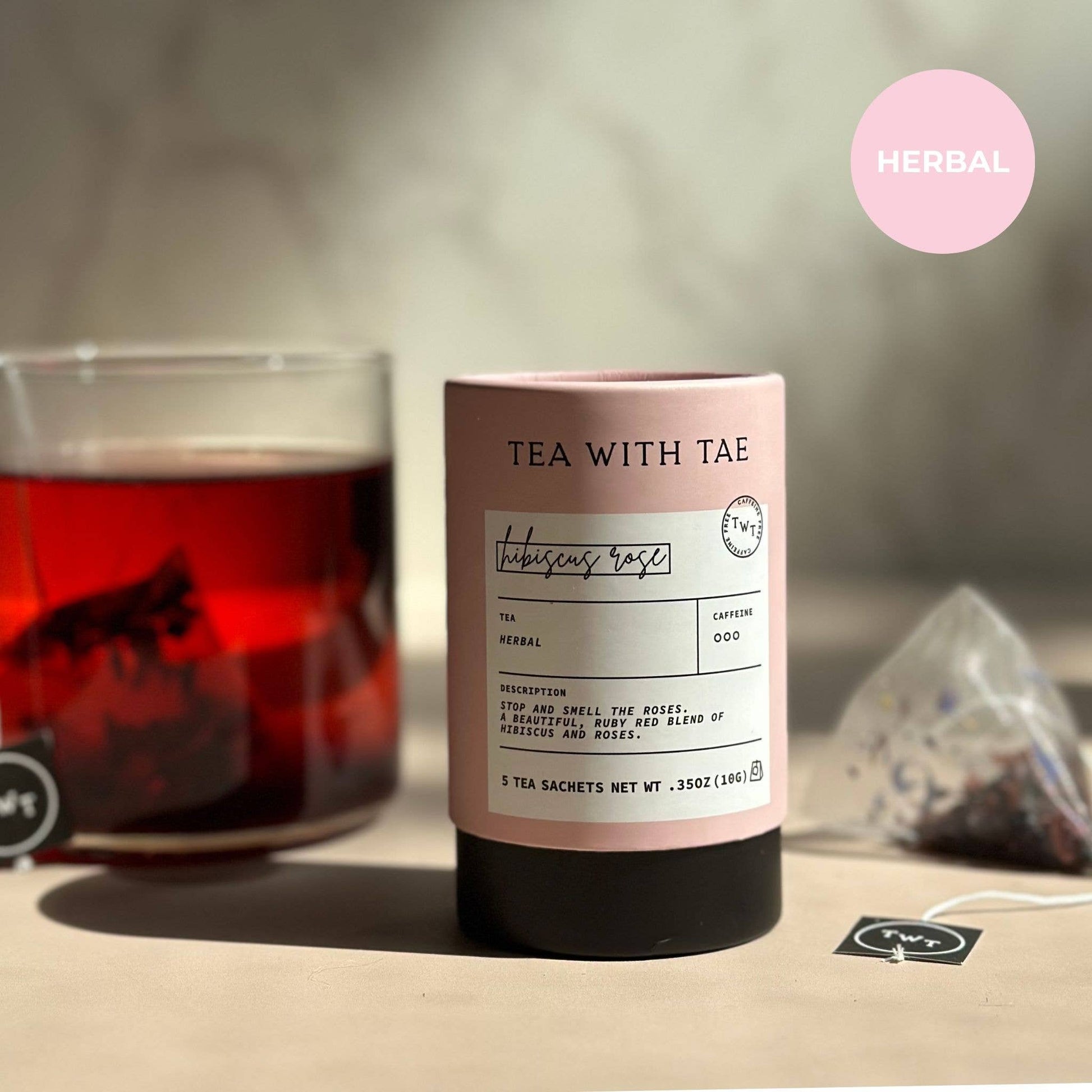 Tea canister labeled 'Tea with Tae' with a glass of tea in the background