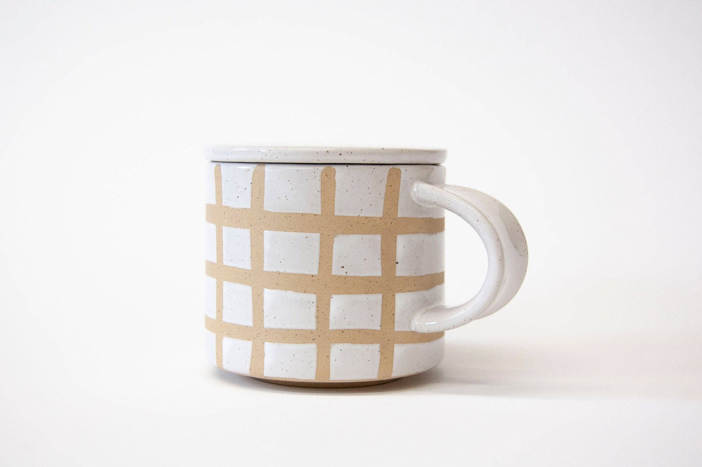 Ceramic mug with beige checkered pattern on a white background