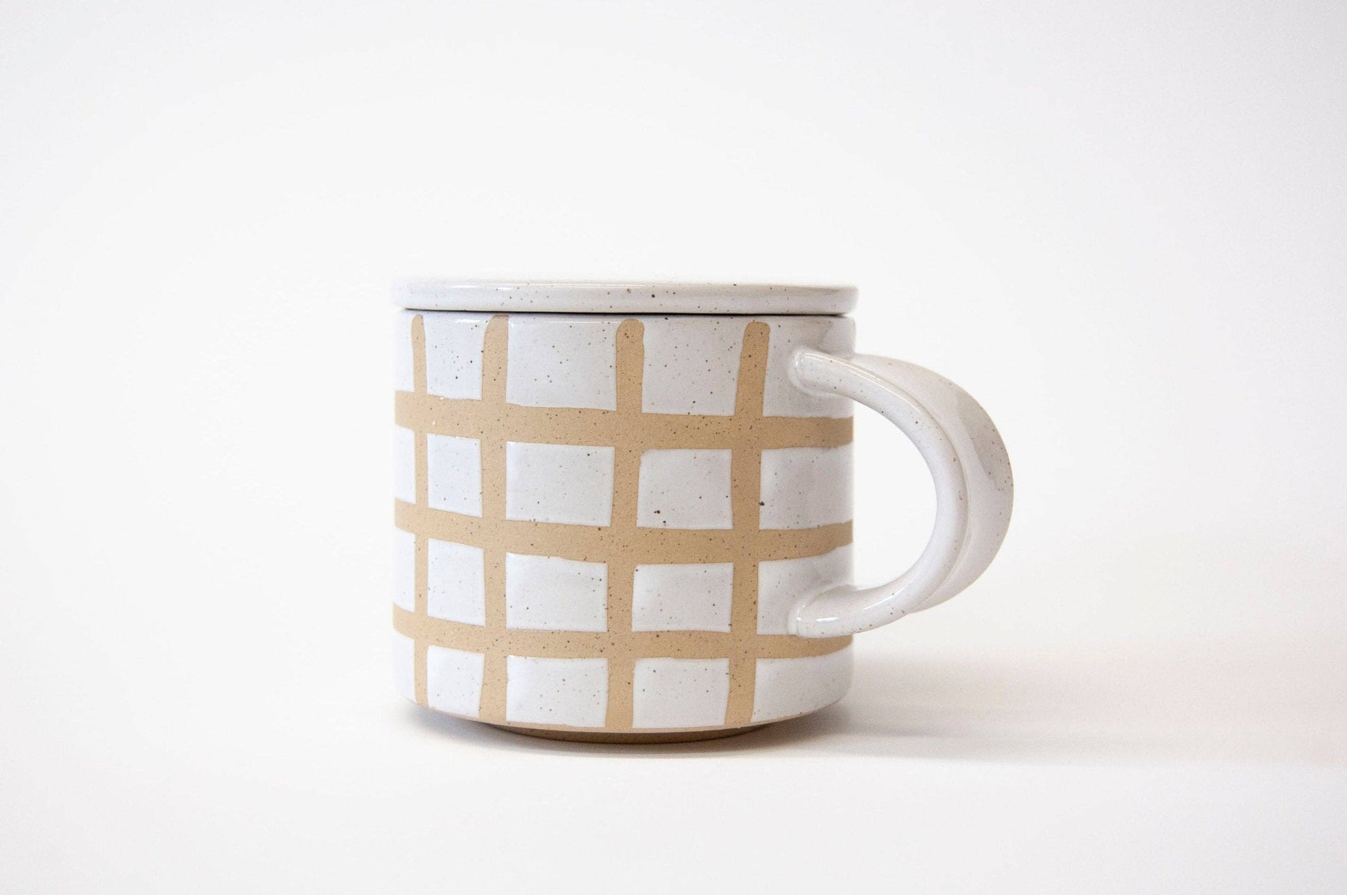 Ceramic mug with beige checkered pattern on a white background