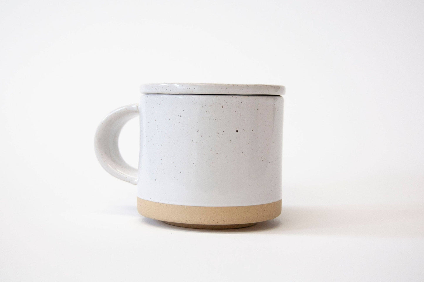 Speckled ceramic mug on a white background