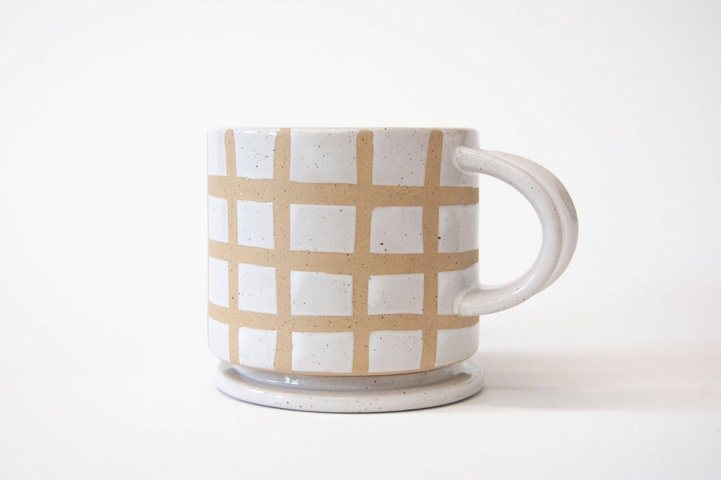 Ceramic mug with a grid pattern on a white background