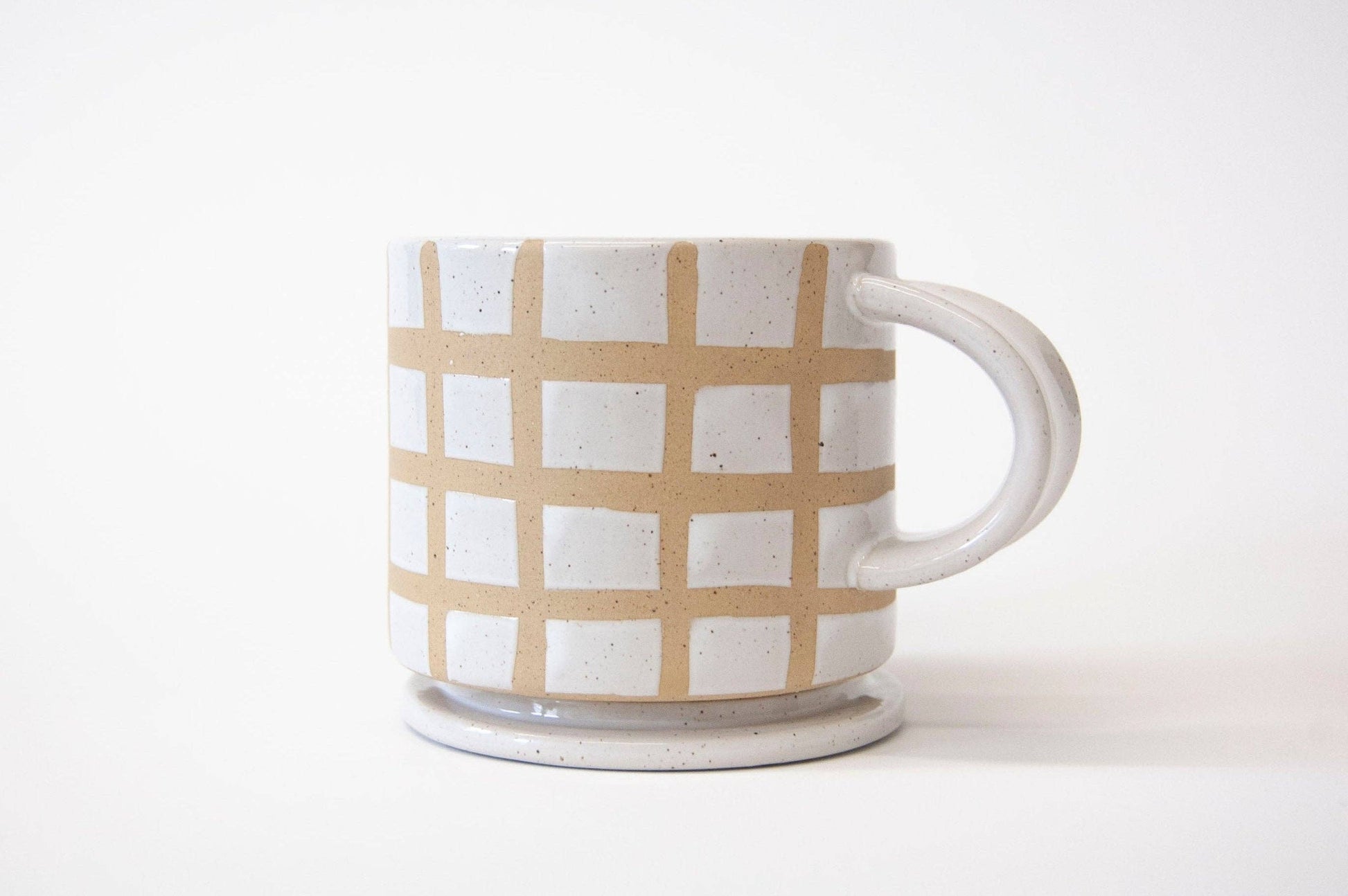 Ceramic mug with a grid pattern on a white background