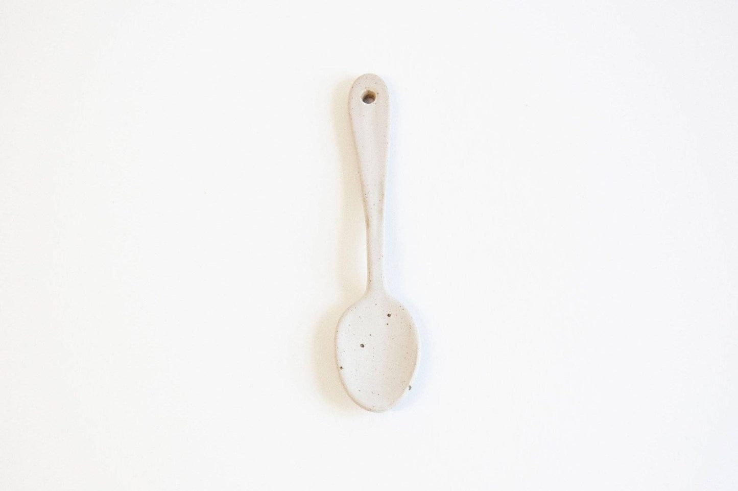 White ceramic spoon on a white background