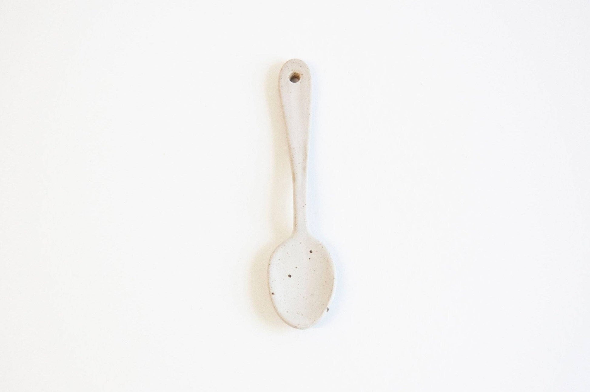 White ceramic spoon on a white background