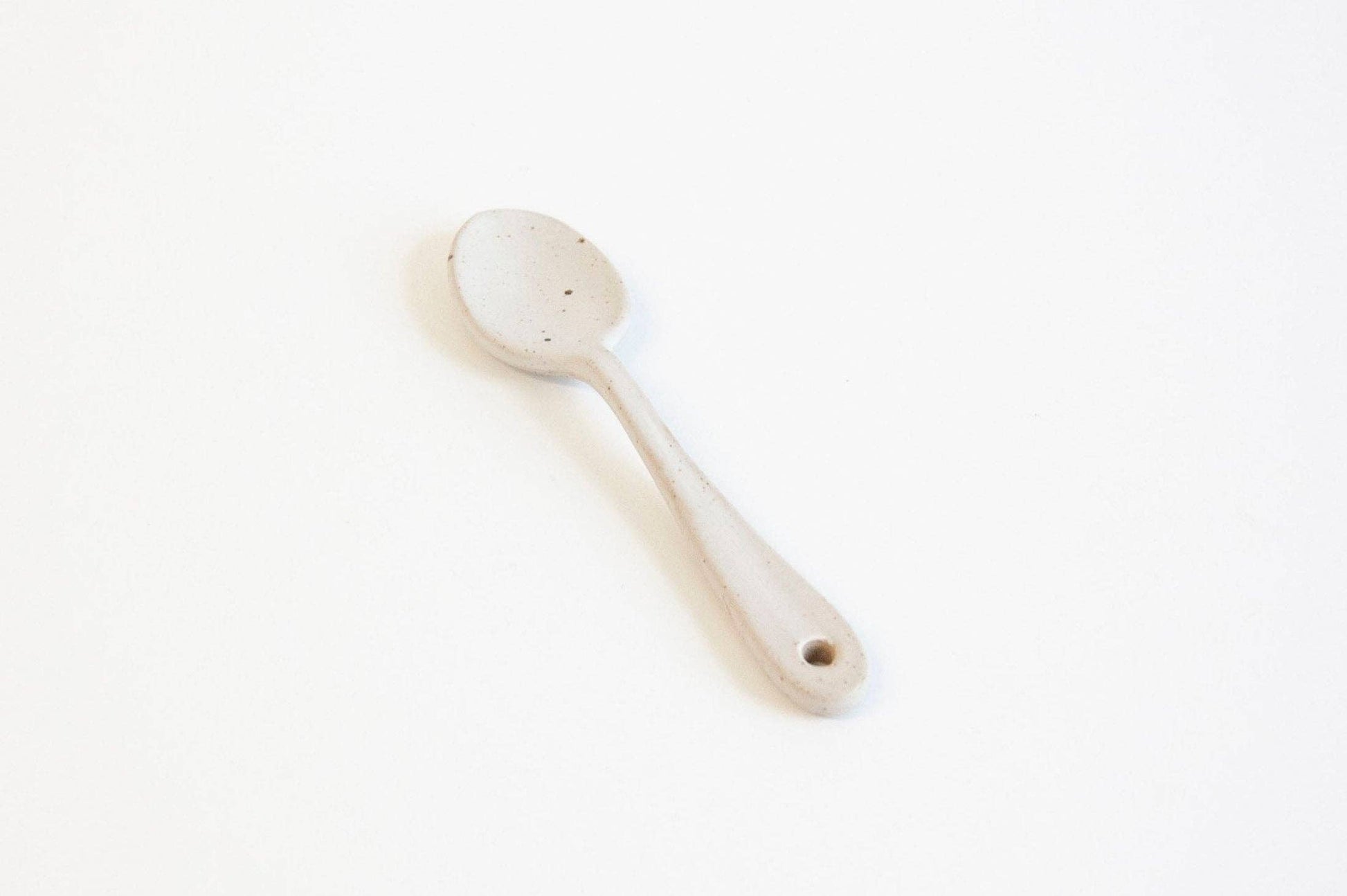 White ceramic spoon on a white background